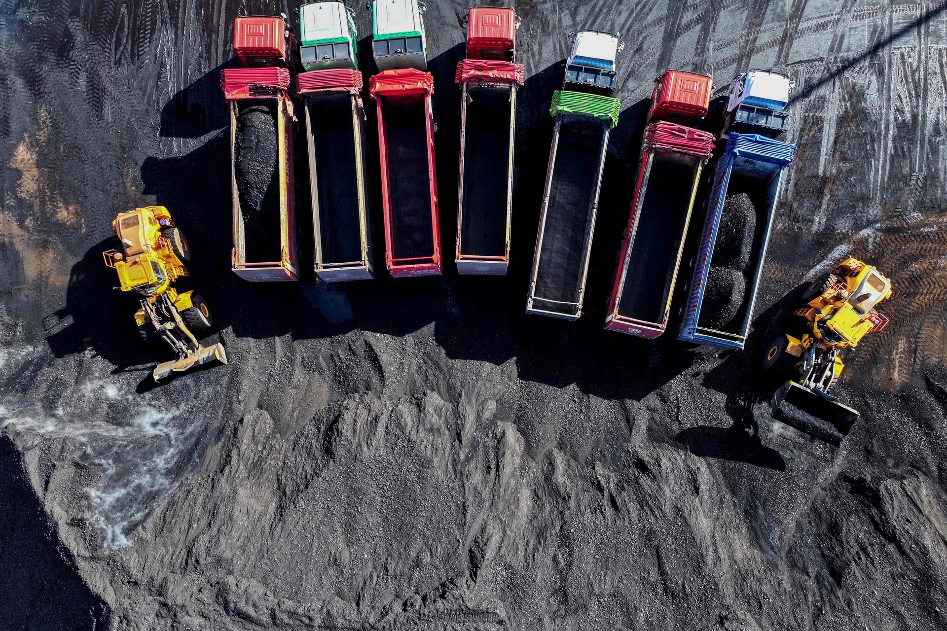 Aerial view of dump trucks loaded with coal at a Chinese open-pit mine